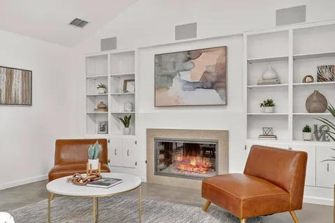 a living room with furniture and a fireplace