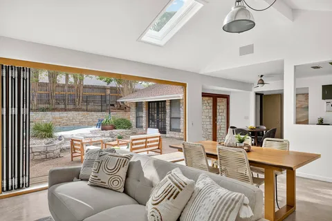 a living room with furniture and large windows
