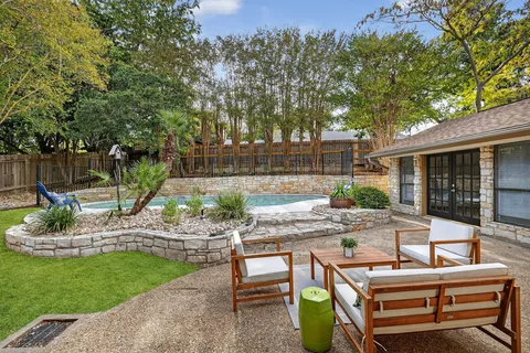 a view of a backyard with sitting area