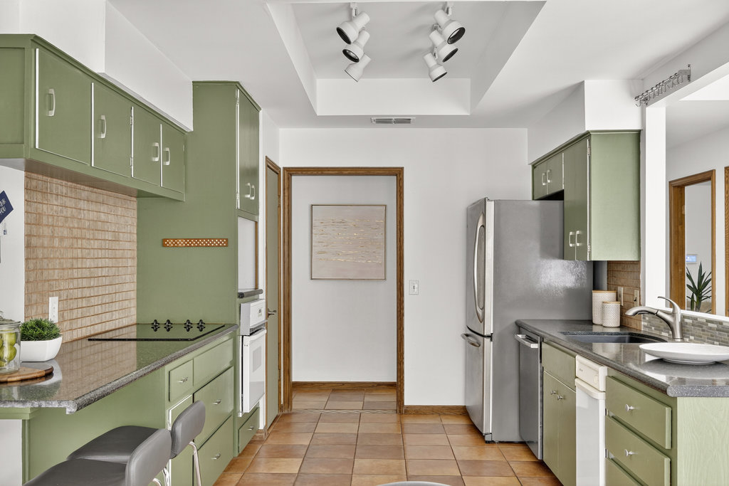 2202 Cypress Point East Austin, TX 78746 - Photo 20 of 36 The kitchen showcases a stylish pop of color with a Mid-Century vibe.