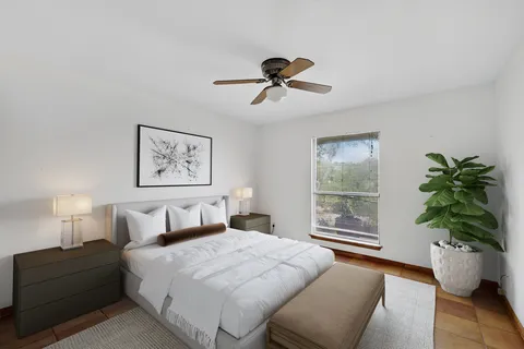 a bedroom with a bed and a potted plant