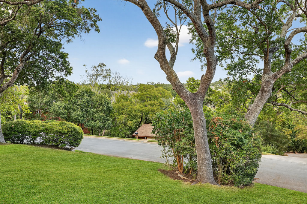 2202 Cypress Point East Austin, TX 78746 - Photo 4 of 36 Perched atop a hill on a tree-line street, you'll find hilltop views at your doorstep.