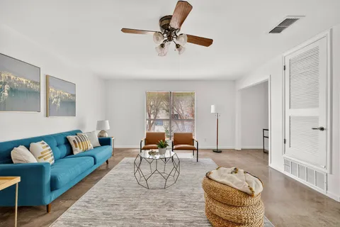 a living room with furniture and white walls
