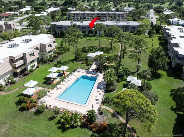 an aerial view of multiple houses with yard
