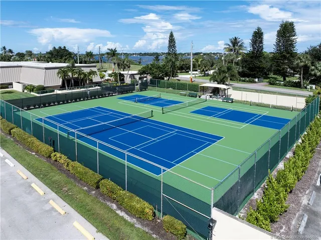 a view of a tennis ground with a large pool