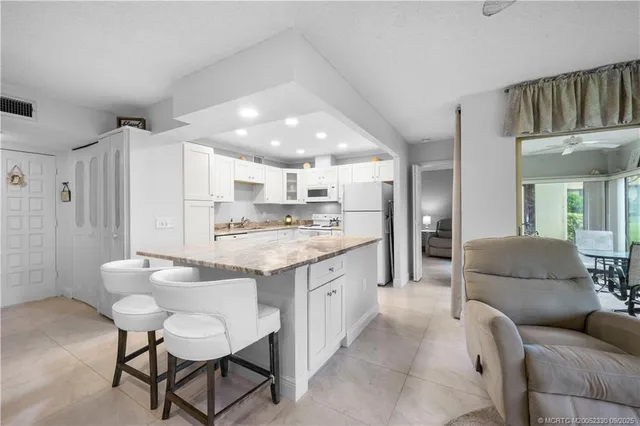 a living room with kitchen island furniture and a kitchen view