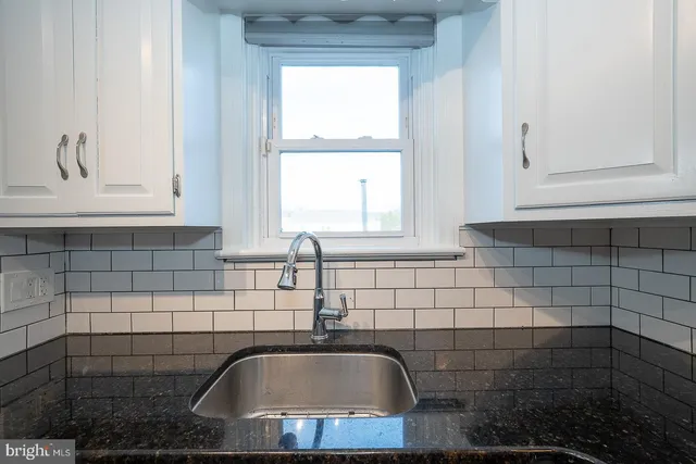 a kitchen with metallic refrigerator freezer and a dishwasher