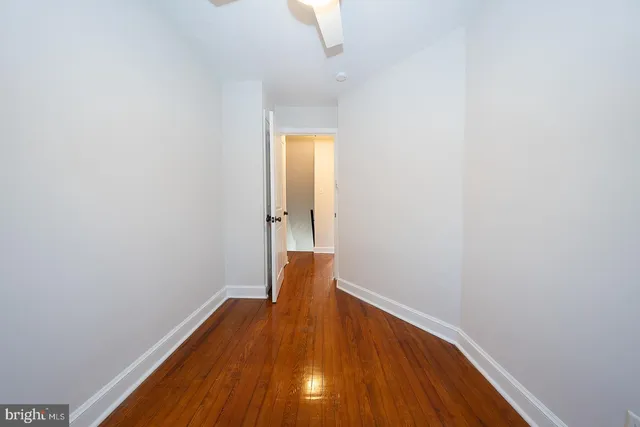 a view of entryway with wooden floor and front door