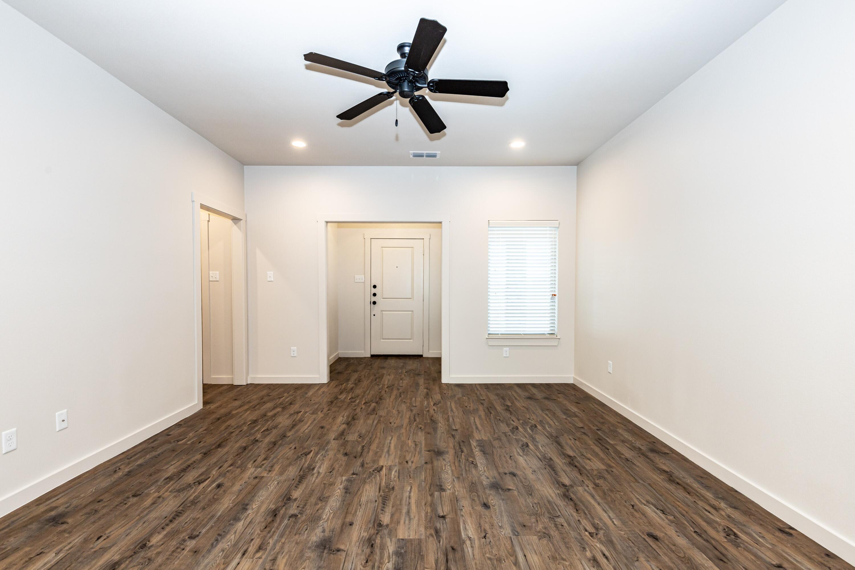 2529 138th Street Lubbock, TX 79423 - Photo 5 of 24 a view of empty room with wooden floor and fan