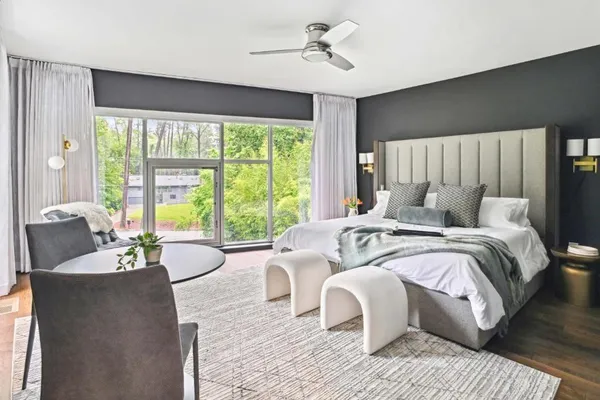 a bedroom with a large bed and a large window