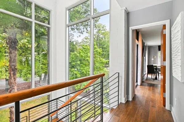a view of a large window with some plants and wooden fence