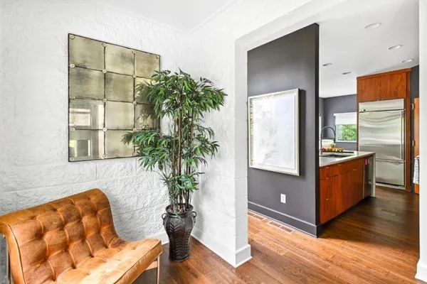 a living room with furniture potted plant and a window