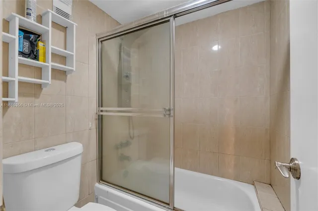 a bathroom with a shower and a toilet