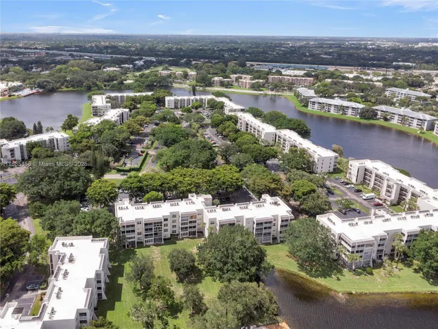 an aerial view of residential houses with outdoor space and river