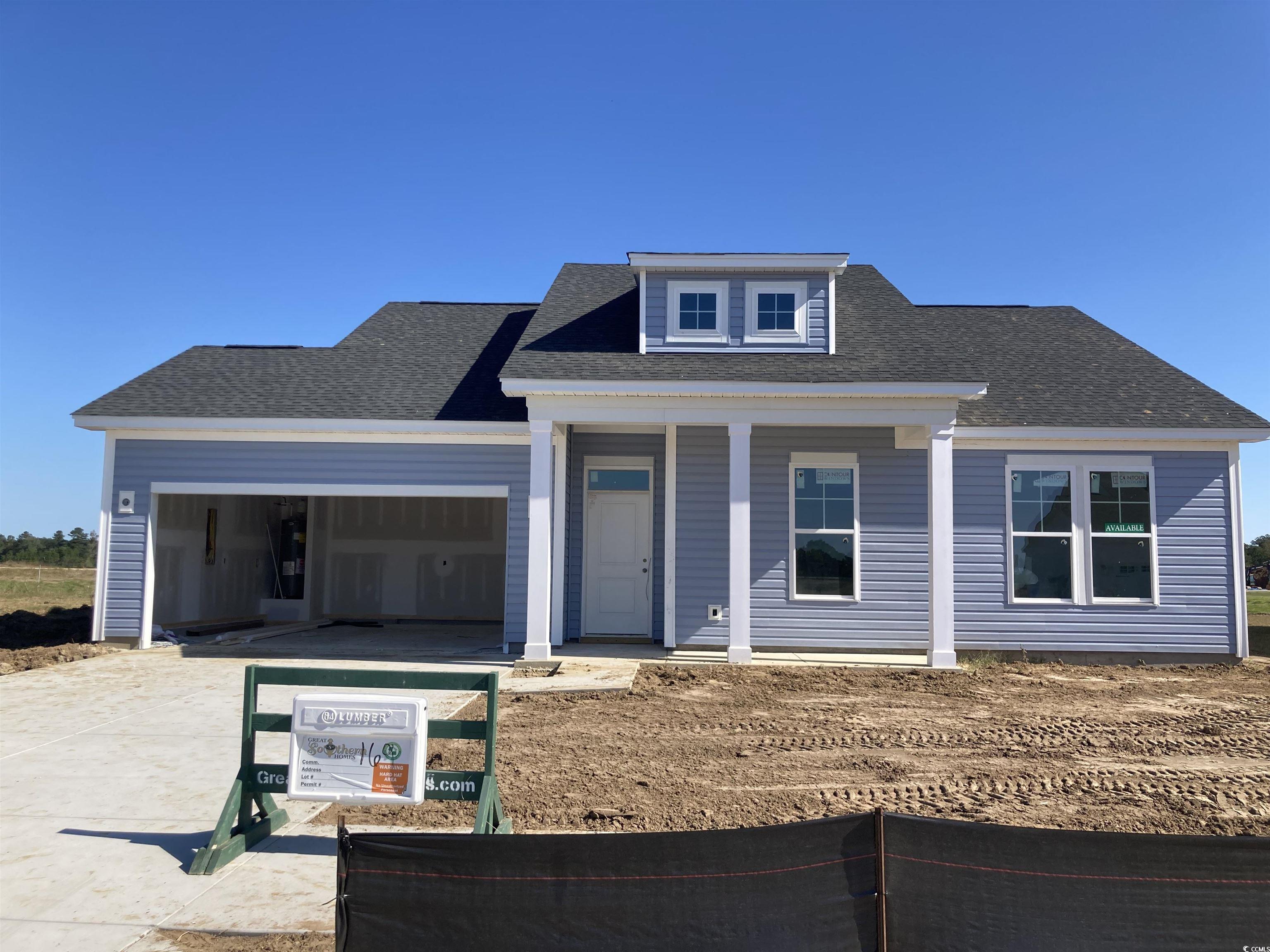 View of front facade featuring covered porch, concrete driveway, a shingled roof, and an attached garage