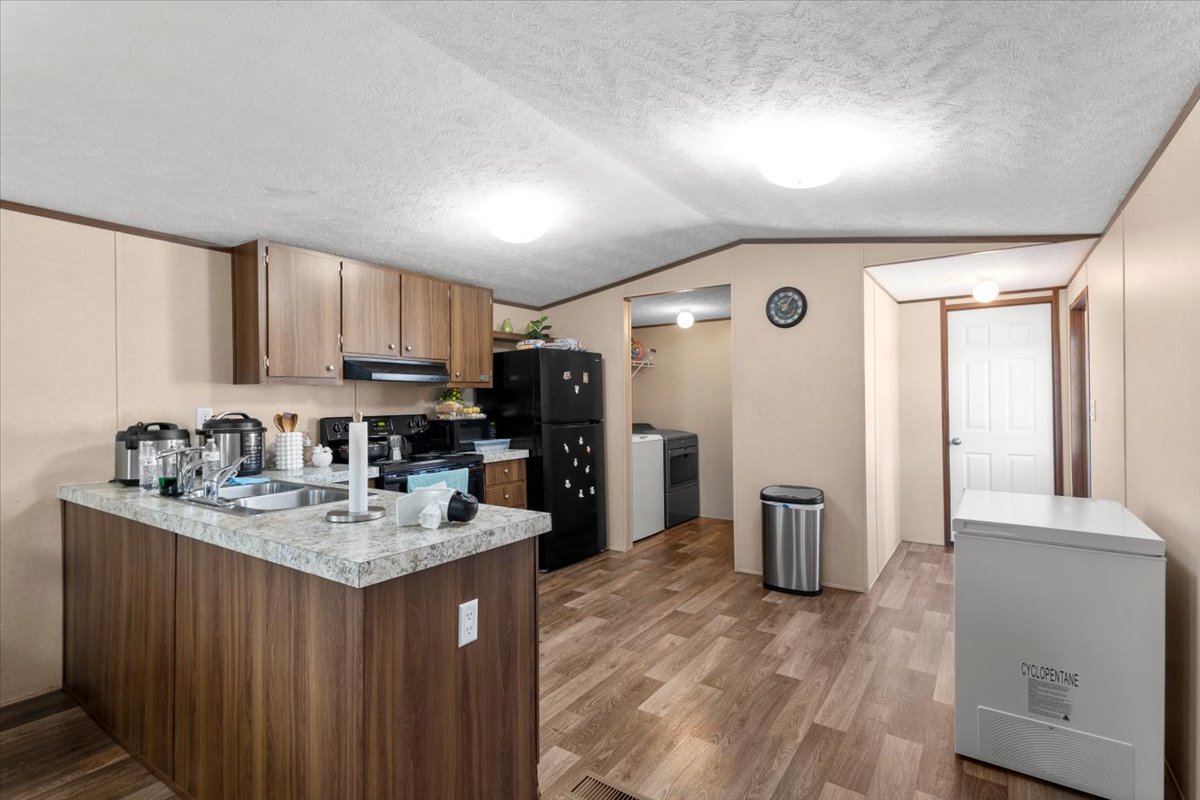 341 Southwest Front Street Bartlett, TX 76511 - Photo 23 of 23 a kitchen with a refrigerator sink and cabinets