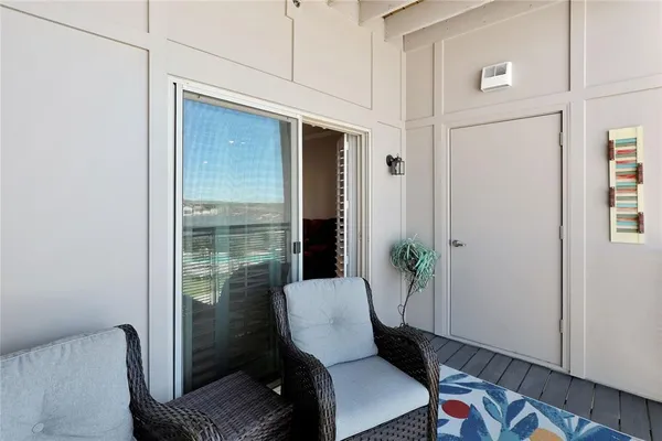 a view of a balcony with chair and table