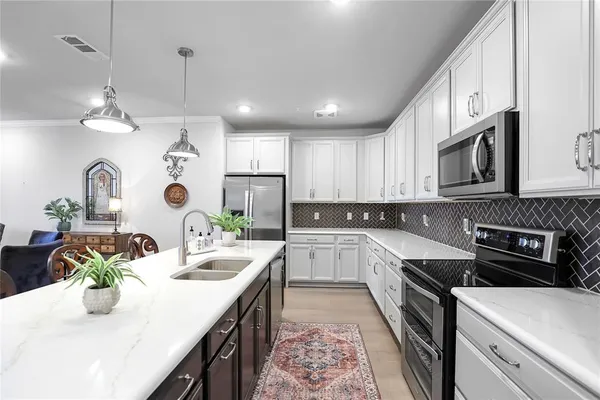 a kitchen with a sink stove and microwave