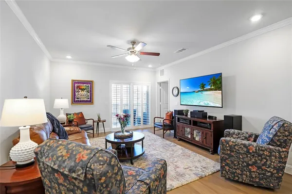 a living room with furniture a rug and a flat screen tv