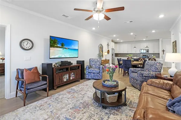 a living room with furniture and wooden floors