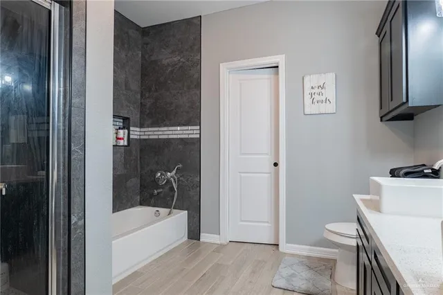 a bathroom with a bathtub a toilet and a shower