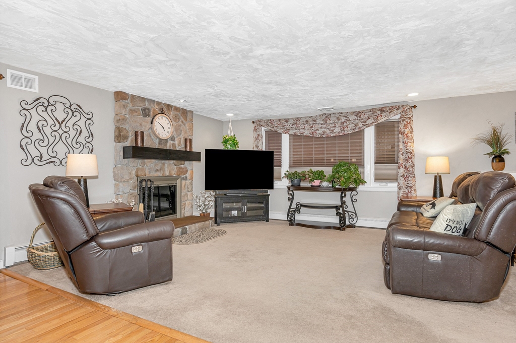 6 Montclair Circle Billerica, MA 01821 - Photo 11 of 42 a living room with furniture a fireplace and a flat screen tv