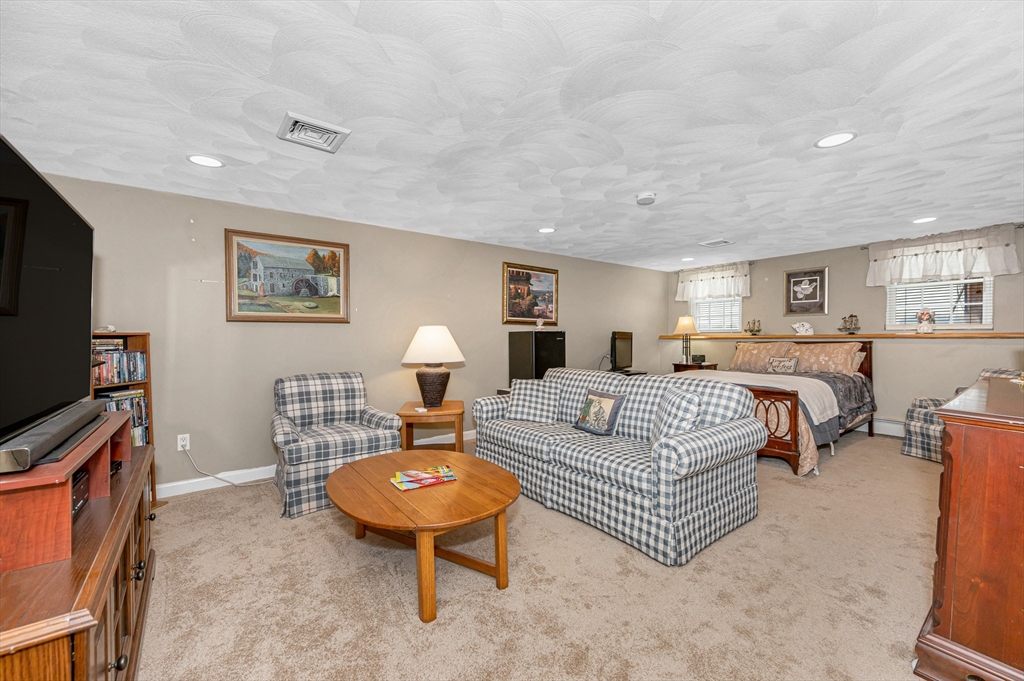 6 Montclair Circle Billerica, MA 01821 - Photo 29 of 42 a living room with furniture a flat screen tv and a table