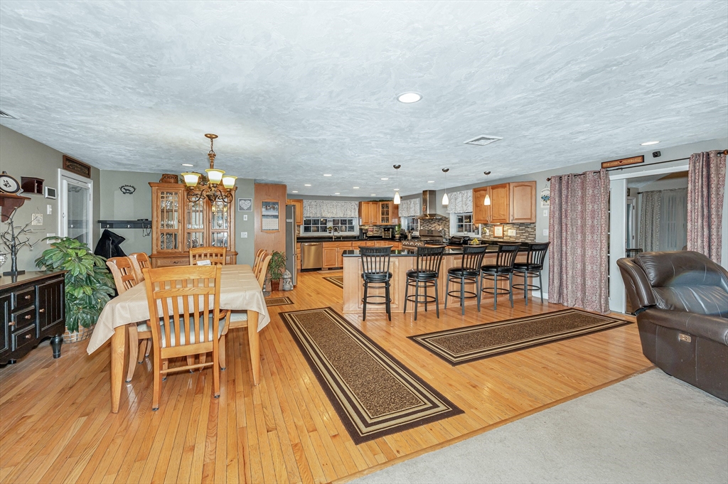 6 Montclair Circle Billerica, MA 01821 - Photo 3 of 42 a living room with furniture a dining table and a wooden floor