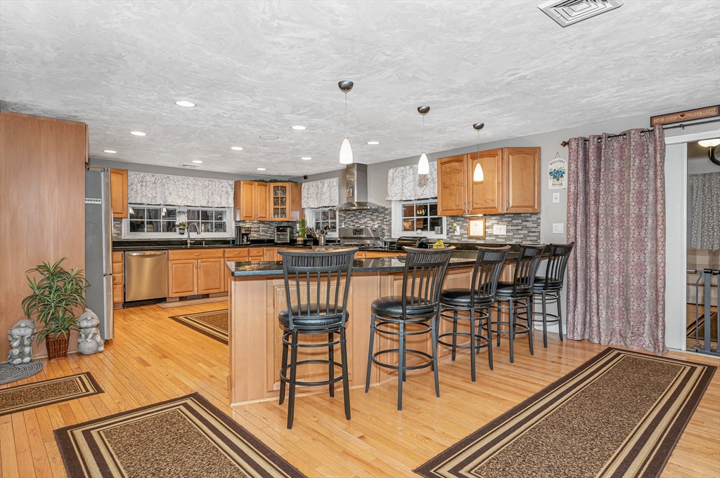 6 Montclair Circle Billerica, MA 01821 - Photo 4 of 42 a dining room with stainless steel appliances granite countertop a table and chairs