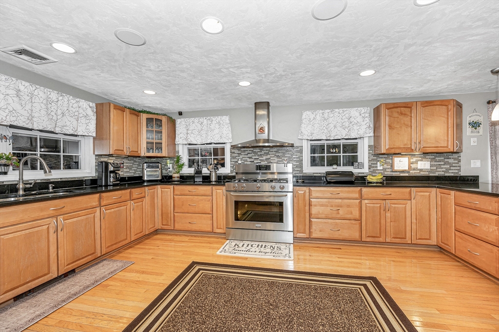 6 Montclair Circle Billerica, MA 01821 - Photo 5 of 42 a kitchen with stainless steel appliances granite countertop a stove a sink and a microwave