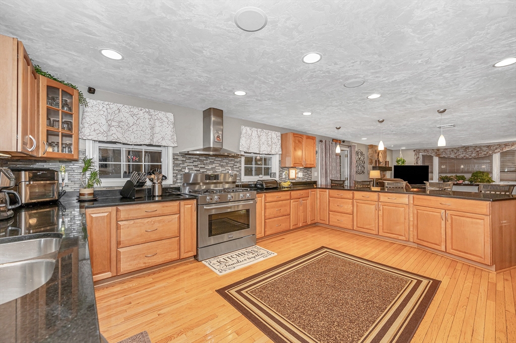 6 Montclair Circle Billerica, MA 01821 - Photo 6 of 42 a kitchen with stainless steel appliances granite countertop a stove a sink and a microwave