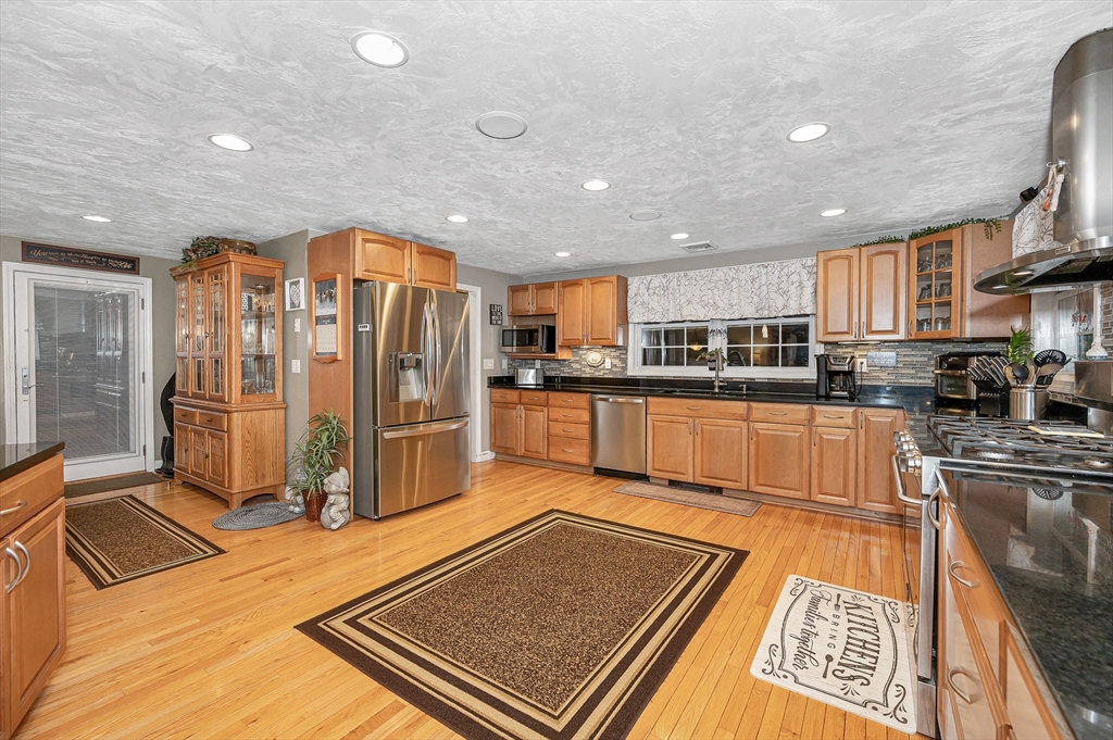 6 Montclair Circle Billerica, MA 01821 - Photo 7 of 42 a kitchen with stainless steel appliances granite countertop a refrigerator and a stove top oven