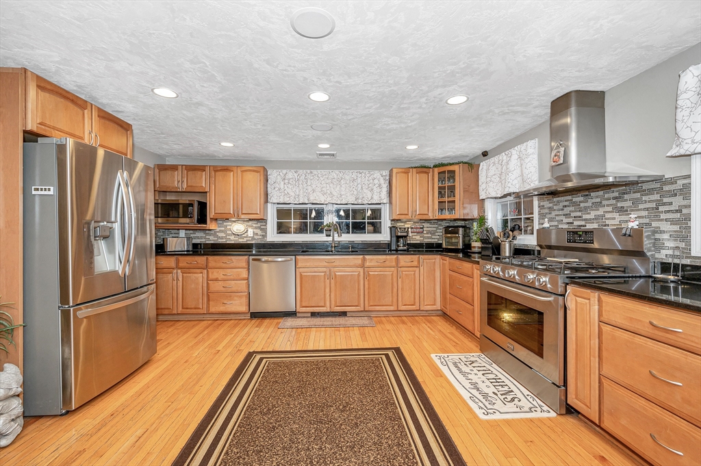 6 Montclair Circle Billerica, MA 01821 - Photo 8 of 42 a large kitchen with stainless steel appliances granite countertop a stove top oven a refrigerator and a granite counter tops