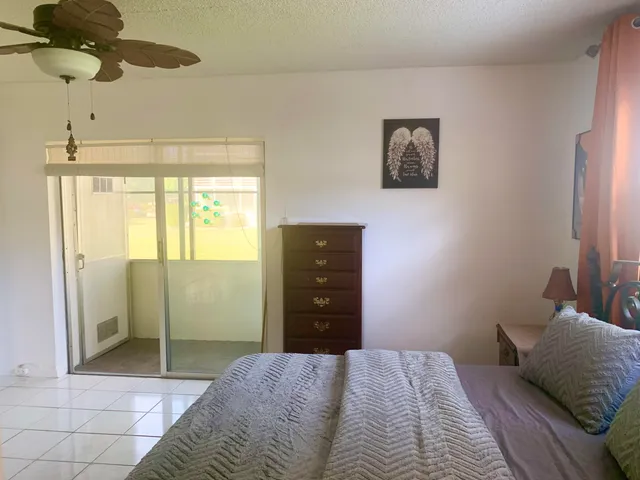 a bathroom with a glass door shower a sink and a mirror
