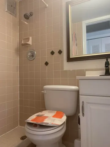 a view of a building with a garden and pathway