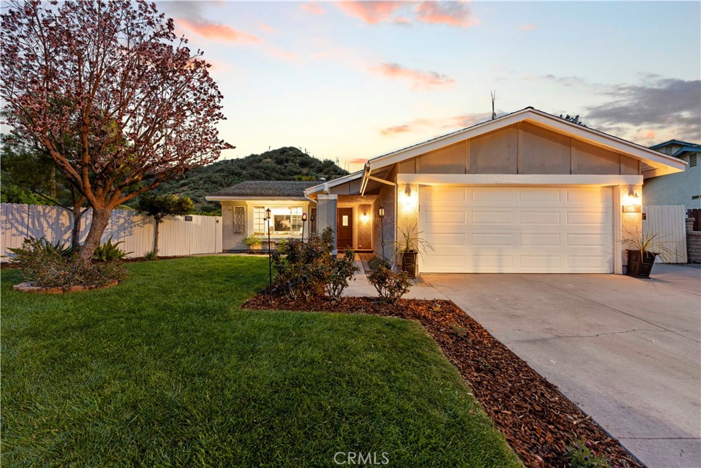 a front view of house with yard and green space