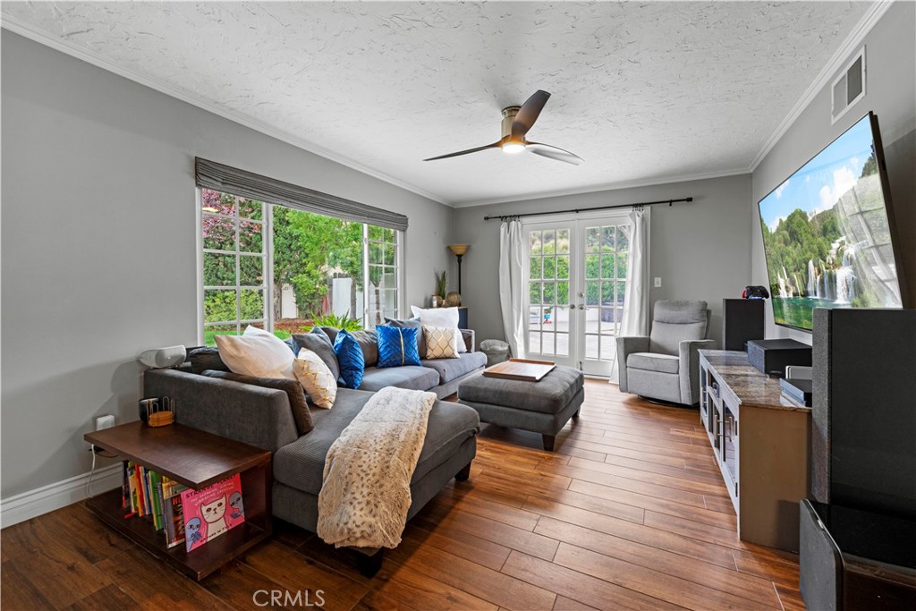 23255 Redbud Ridge Circle Valencia, CA 91354 - Photo 12 of 19 a living room with furniture a large window and a flat screen tv