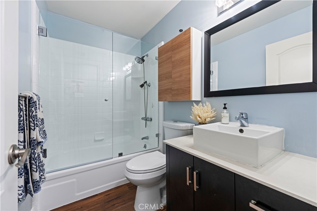 23255 Redbud Ridge Circle Valencia, CA 91354 - Photo 14 of 19 a bathroom with a sink toilet a mirror and shower