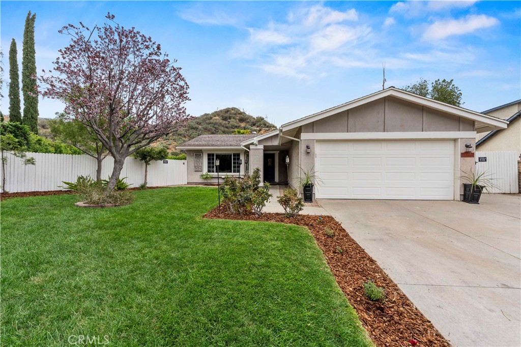 23255 Redbud Ridge Circle Valencia, CA 91354 - Photo 17 of 19 a front view of a house with a yard