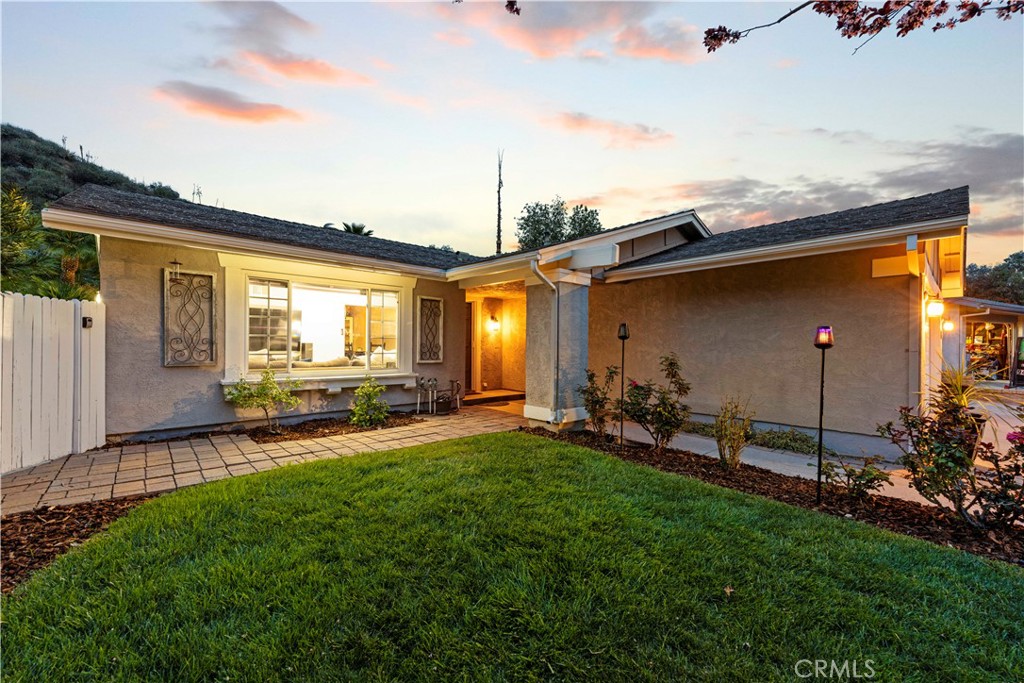 23255 Redbud Ridge Circle Valencia, CA 91354 - Photo 2 of 19 a view of a backyard with plants and a patio