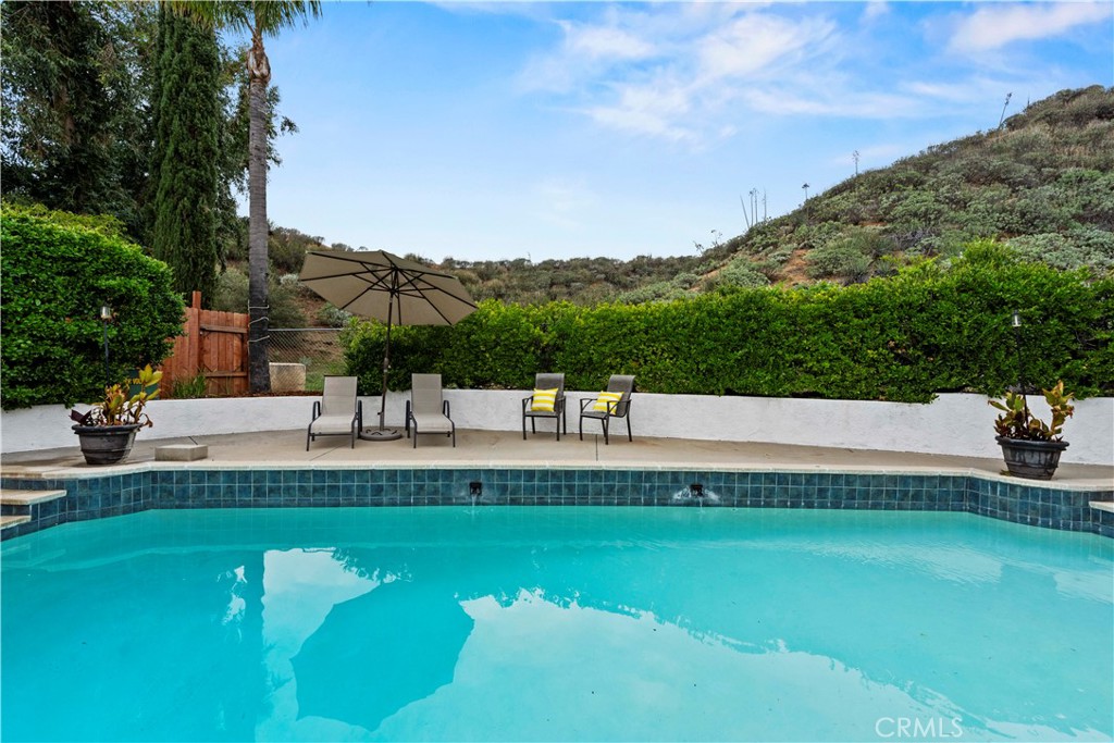 23255 Redbud Ridge Circle Valencia, CA 91354 - Photo 3 of 19 a view of a swimming pool with a garden