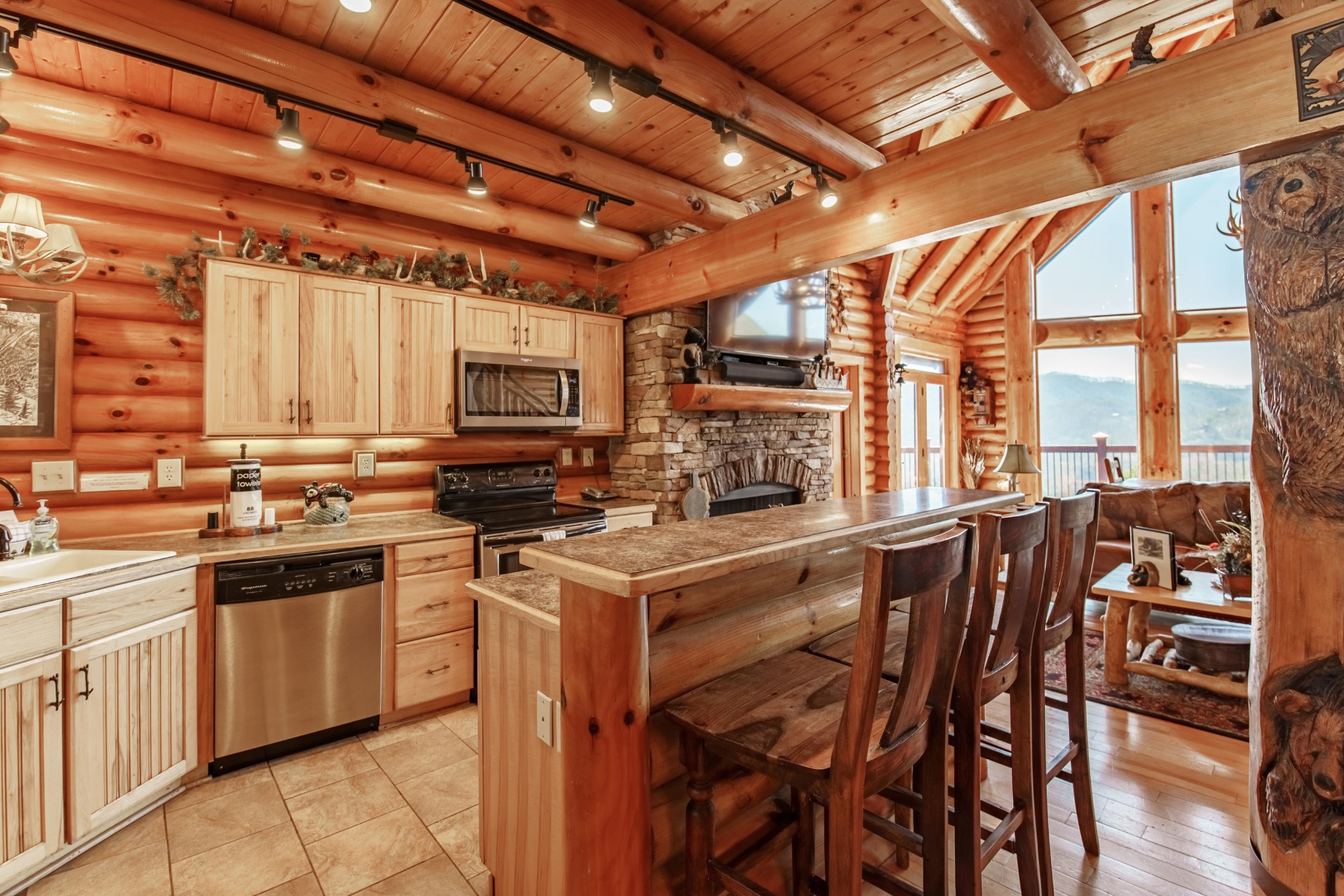 3005 Redtail Road Sevierville, TN 37862 - Photo 12 of 37 a kitchen with stainless steel appliances granite countertop a stove top oven a sink with a dining table and chairs