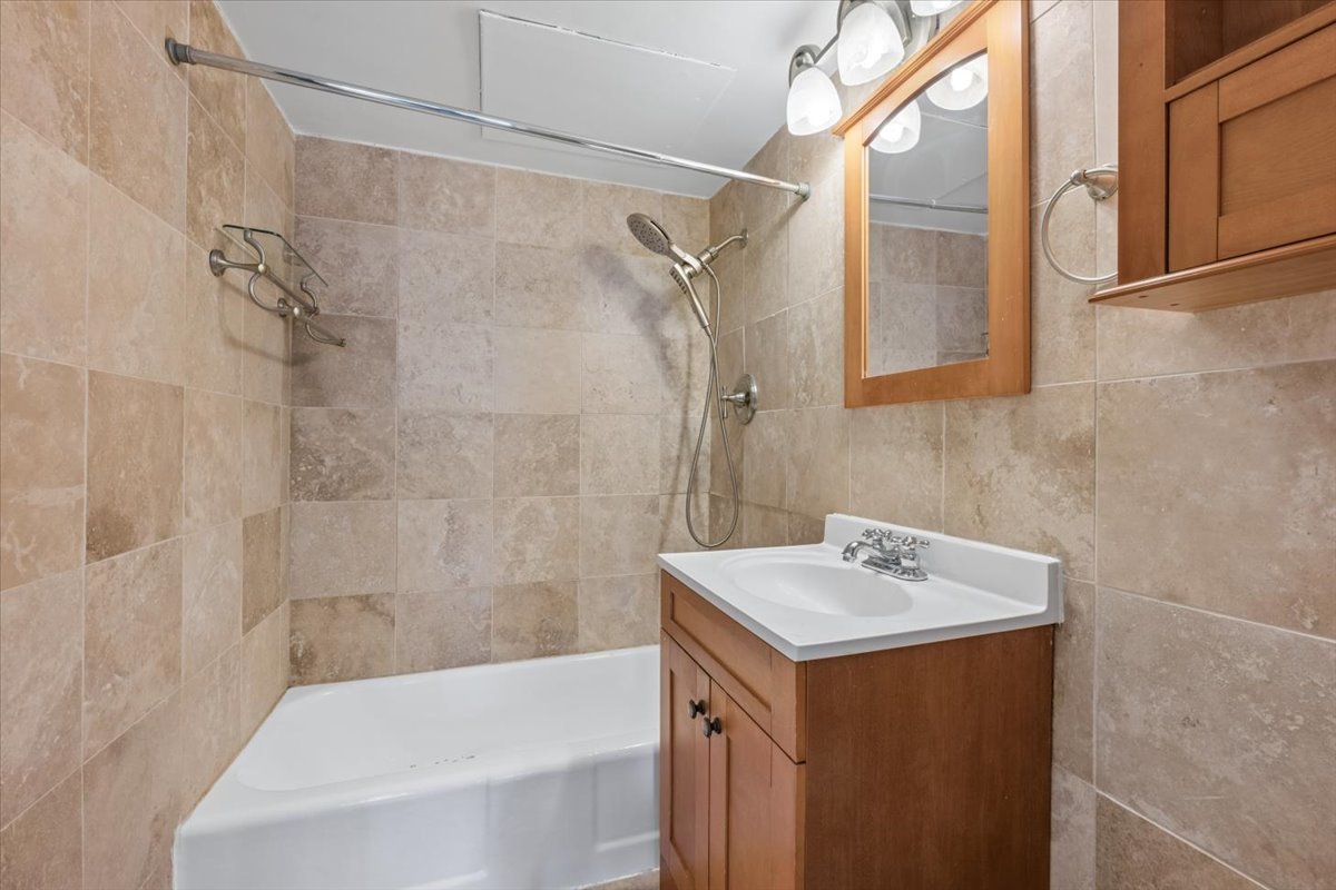 253 East Delaware Place, Unit 11F Chicago, IL 60611 - Photo 7 of 19 a bathroom with a sink and a bathtub