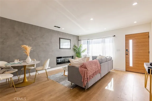 a view of a hallway with entryway wooden floor and front door