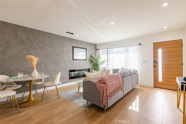 a view of a hallway with entryway wooden floor and front door
