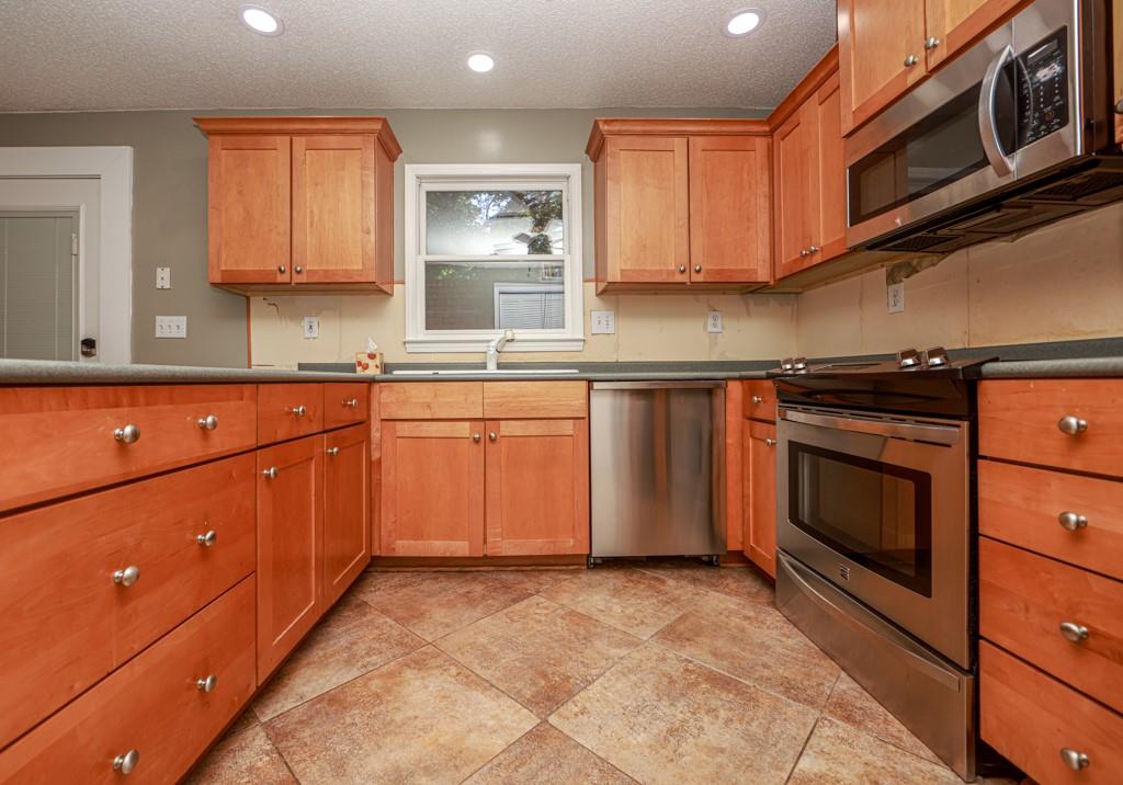 1101 Scott Boulevard Decatur, GA 30030 - Photo 11 of 27 a kitchen with stainless steel appliances granite countertop a stove and a sink