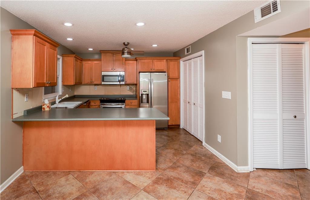 1101 Scott Boulevard Decatur, GA 30030 - Photo 12 of 27 a kitchen with stainless steel appliances granite countertop a stove a sink and a refrigerator