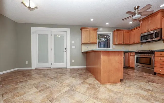 a kitchen with stainless steel appliances granite countertop a stove and a sink