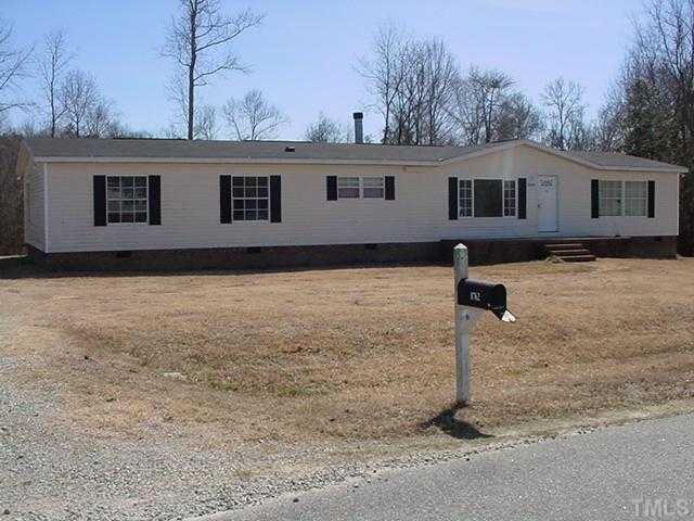 8762 Creek Road Willow Spring, NC 27592 - Photo 1 of 3 a front view of a house with yard