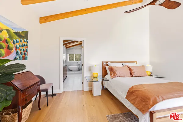 a bedroom with a bed and a dresser in it